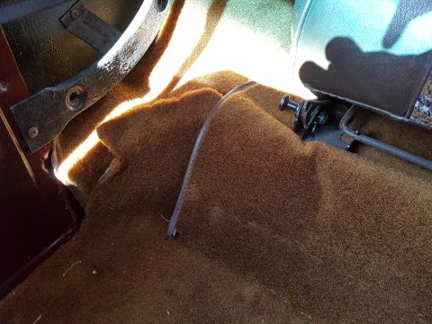 1978 Ford Bronco - Close-up view of the interior floor and seat mounting hardware in a 1978 Ford Bronco.
