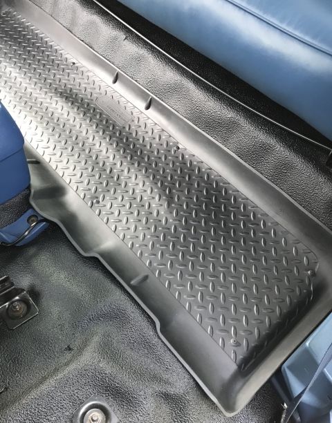 1995 Ford Bronco - Close-up of a diamond plate floor mat inside a vehicle's interior.
