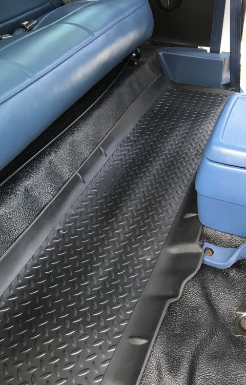 1995 Ford Bronco - Interior view showing diamond plate flooring and blue seats.