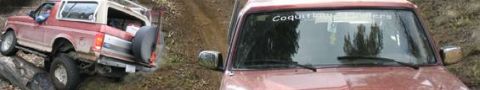 1987 Ford Bronco - This 1987 Ford Bronco is navigating a challenging off-road course, demonstrating its capability on rough terrain.