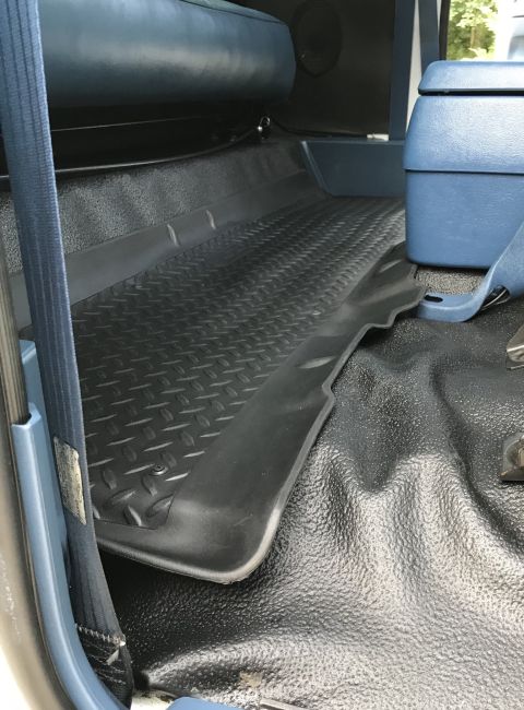 1995 Ford Bronco - Interior view of a vehicle's floor mats and seats.