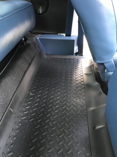 1995 Ford Bronco - Diamond plate floor mats cover the carpeted floor in front of blue vinyl seats.