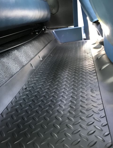 1995 Ford Bronco - Close-up of the diamond plate flooring and blue interior of a vehicle.
