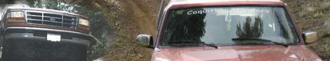 1987 Ford Bronco - 1987 Ford Bronco front view on a dirt road with "Coquitlam Crawlers" sticker on windshield.