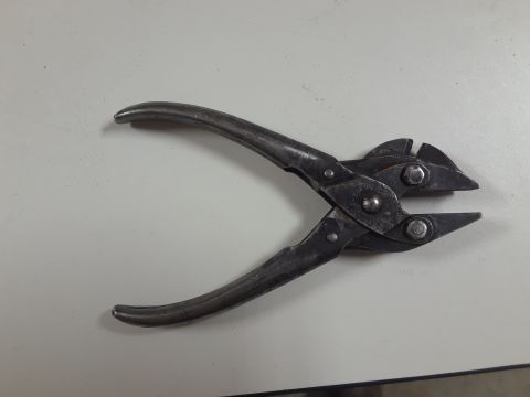 1994 Ford Bronco - A pair of metal pliers is shown against a neutral background.
