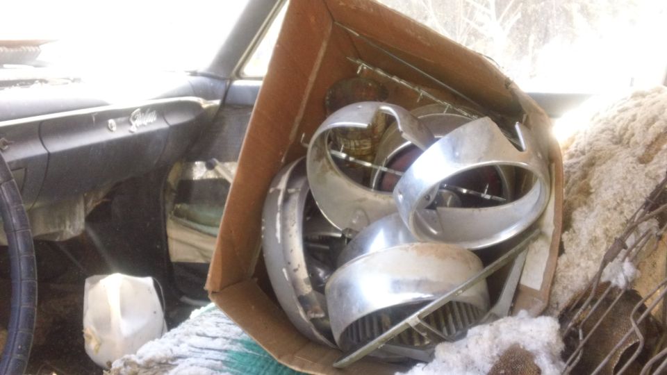 1961 Ford Starliner interior with a box of chrome trim parts