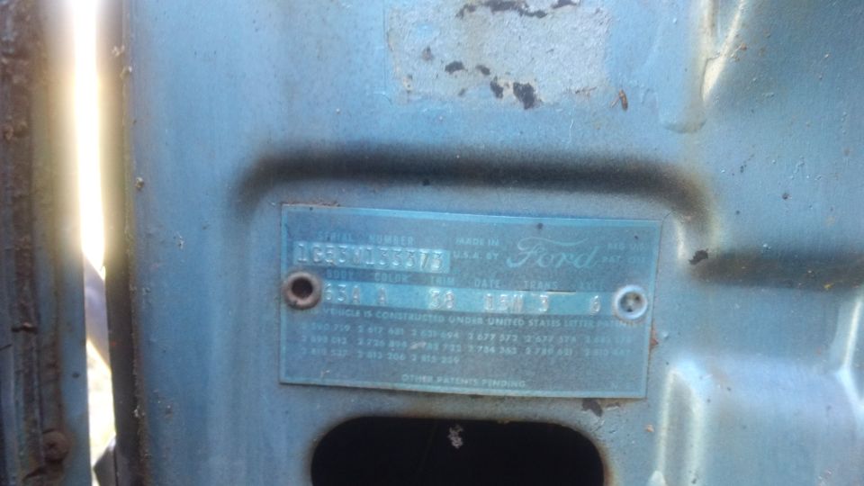 1961 Ford VIN plate on blue metal, showing model year and other details
