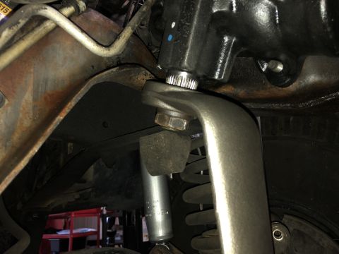1995 Ford Bronco - Close-up view of the steering gear box and suspension components, including a shock absorber and coil spring.