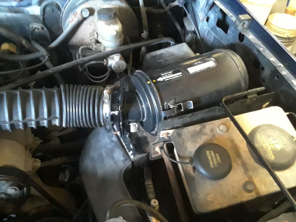 Engine bay with air intake system and fluid reservoirs visible