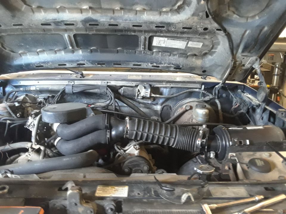 1996 Ford F-350 engine bay with air intake and hoses visible