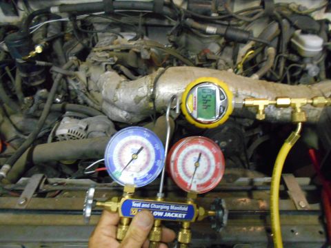 1992 Ford Bronco - AC manifold gauges connected to an engine bay, showing a reading of 445.0 on the digital gauge.