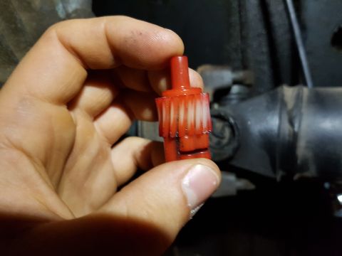1978 Ford Bronco - A red plastic gear with white teeth is held up against a dark mechanical background, with a Supermotors logo visible at the bottom.