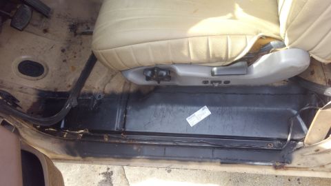 1990 Ford F-250 - Interior view of the passenger side floor and seat base of a 1990 Ford F-250.