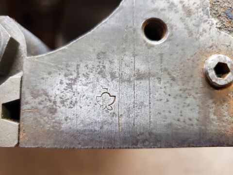 1963 Ford Fairlane - Close-up of a metal component showing a stamped symbol and machining marks.