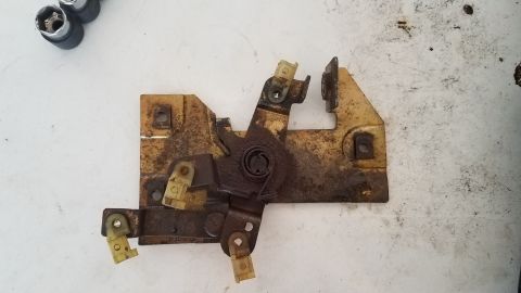 1985 Ford Bronco - A close-up of a corroded car door latch mechanism, likely for an older vehicle.