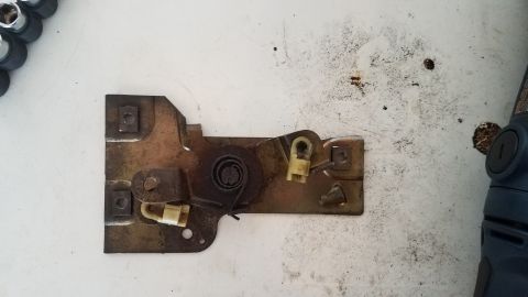 1985 Ford Bronco - A close-up view of a vehicle's door latch mechanism, showing its internal components and springs.