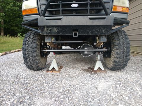 1995 Ford Bronco - Front axle and suspension of a 1995 Ford Bronco, lifted and on jack stands.