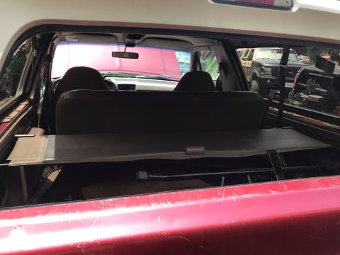 1994 Ford Bronco - View from the back of an SUV, showing the interior and another vehicle outside.