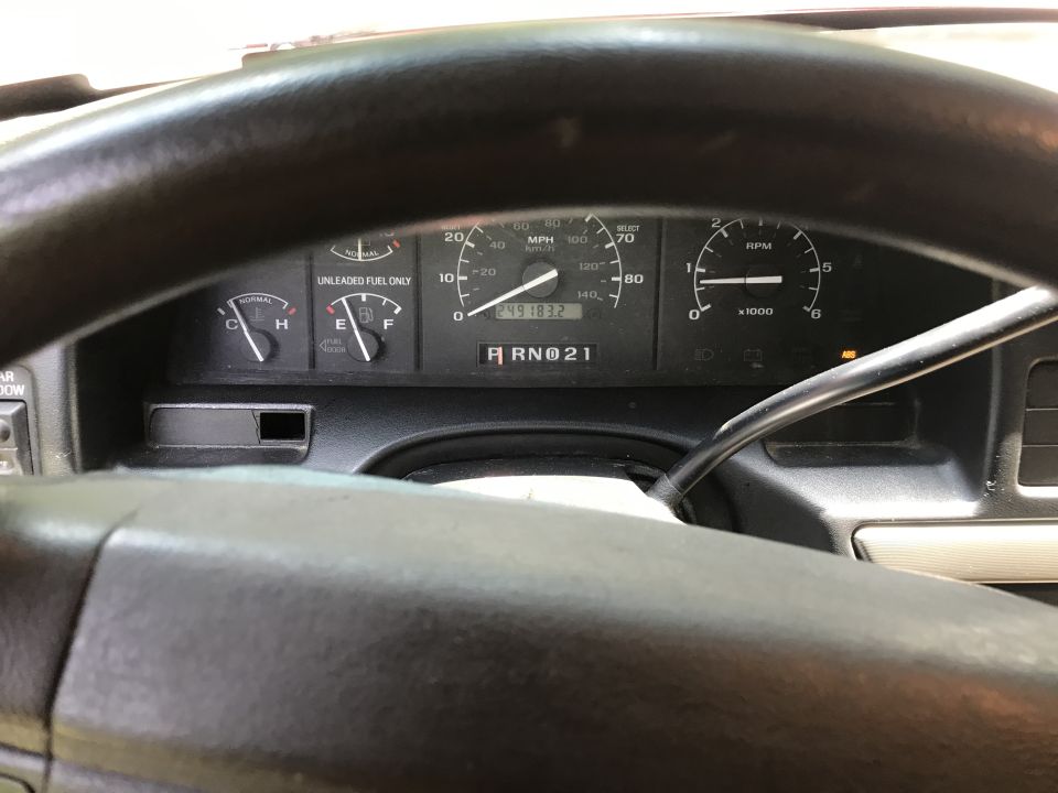 Dashboard gauges of a 1994 Ford Bronco, showing speedometer, fuel gauge, and RPM meter