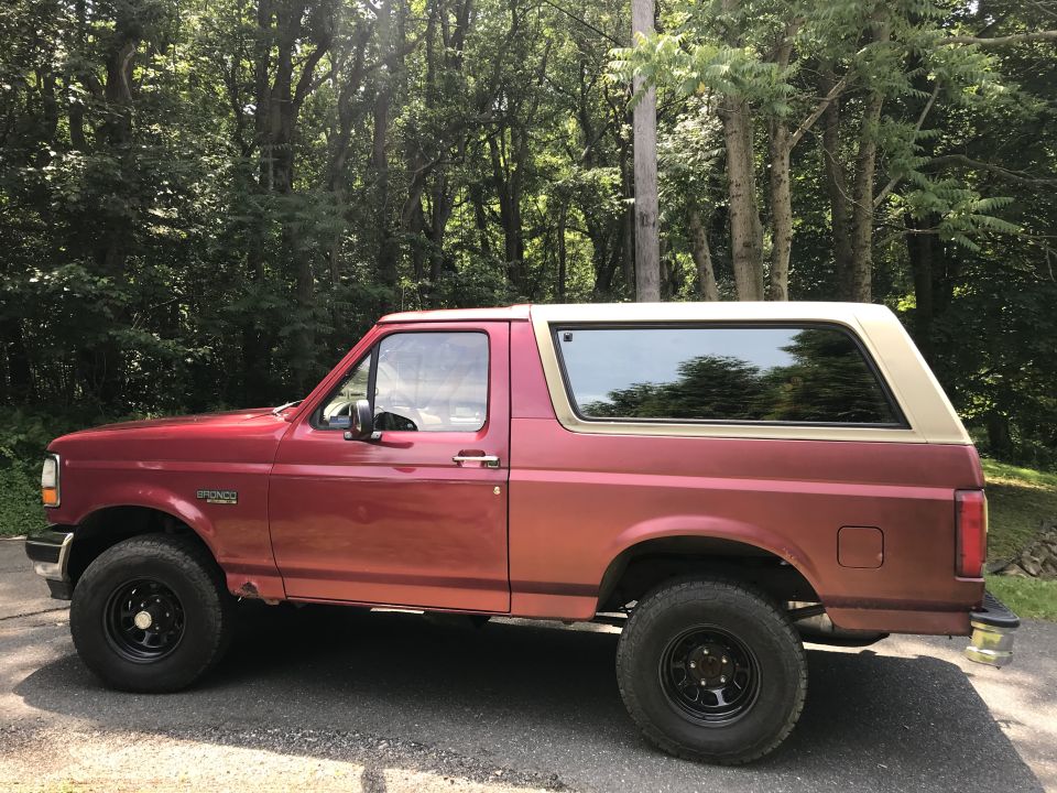 Red and tan 1994 Ford Bronco, side view