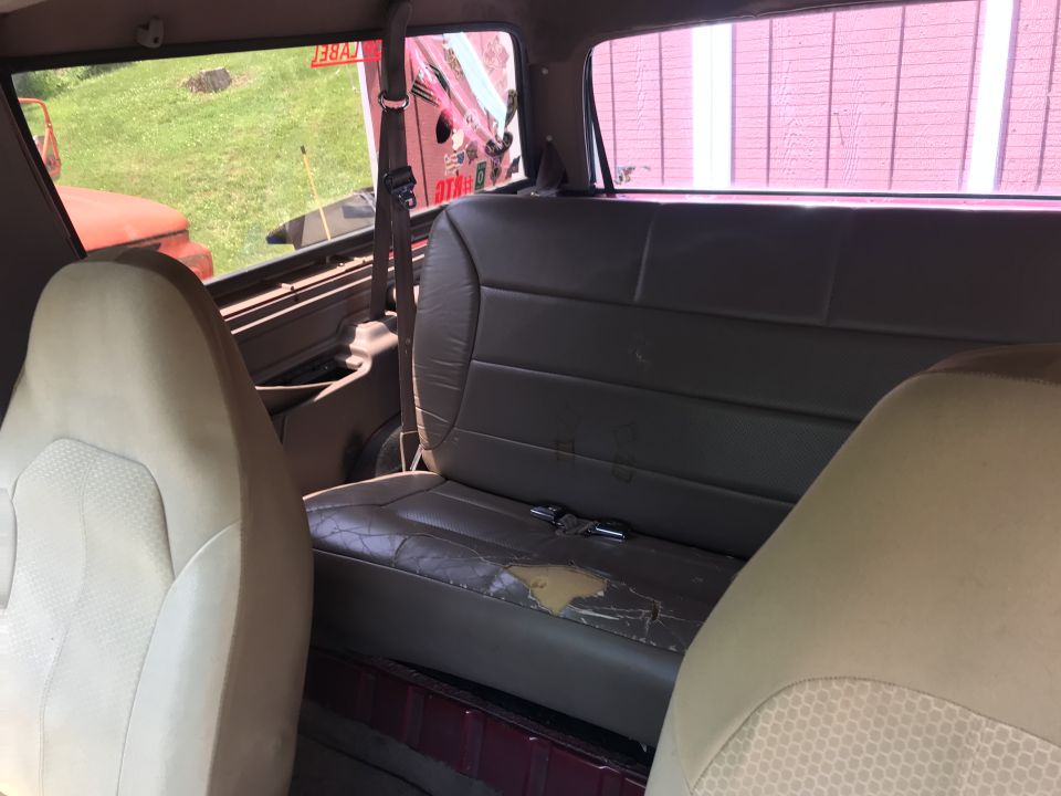 Interior view of a 1994 Ford Bronco showing rear seats and side window