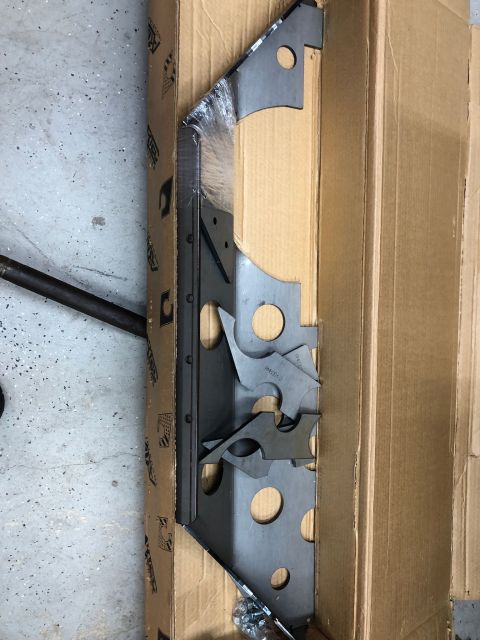 1992 Jeep Wrangler - Unidentified metal brackets, possibly for a vehicle drivetrain, are shown in their packaging.