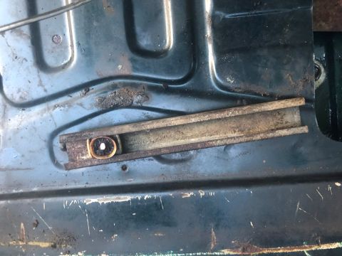1995 Ford Bronco - This image shows a close-up of a rusty window regulator mechanism, likely from a vehicle door.