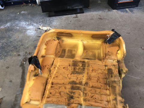 1995 Ford Bronco - The exposed foam and damaged upholstery of a car seat are visible, indicating wear and tear.