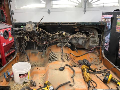 1992 Jeep Wrangler - The interior of a Jeep is shown with the dashboard and wiring harness completely disassembled, revealing the inner workings.