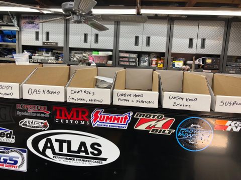 1992 Jeep Wrangler - Organized storage boxes with labels for vehicle parts are displayed in a garage setting.