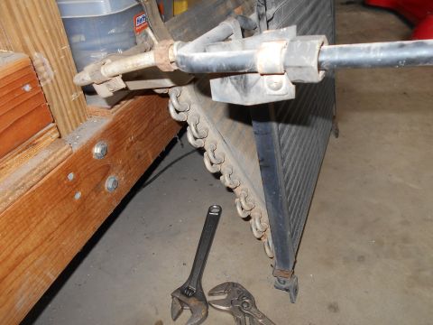 1992 Ford Bronco - Radiator assembly with attached hoses and two adjustable wrenches on the floor.