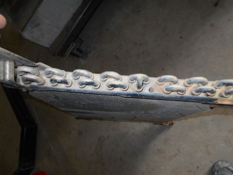 1992 Ford Bronco - Undercarriage component with a visible chain-like structure.