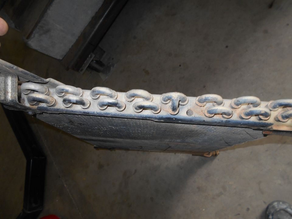 Close-up of a metal chain assembly on a vehicle's undercarriage