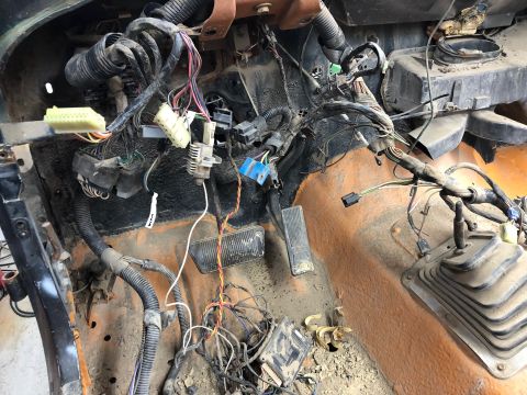 1992 Jeep Wrangler - The complex wiring harness of a vehicle's interior is exposed during a tear-down process.