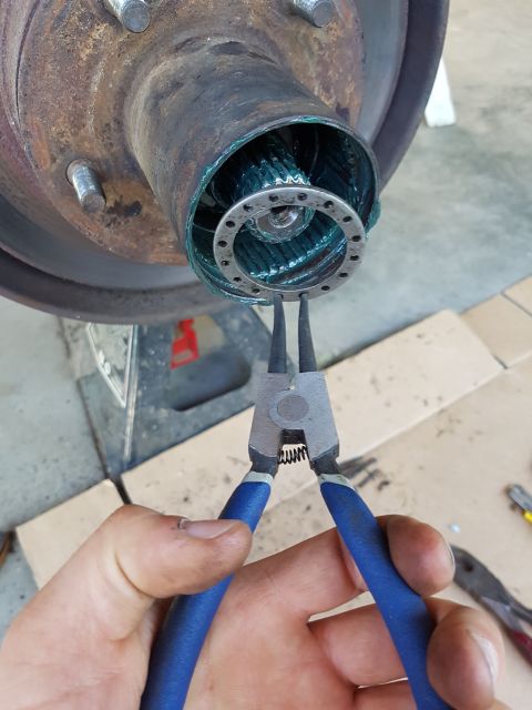 1978 Ford Bronco - Removing a snap ring from a greased splined shaft using snap ring pliers.