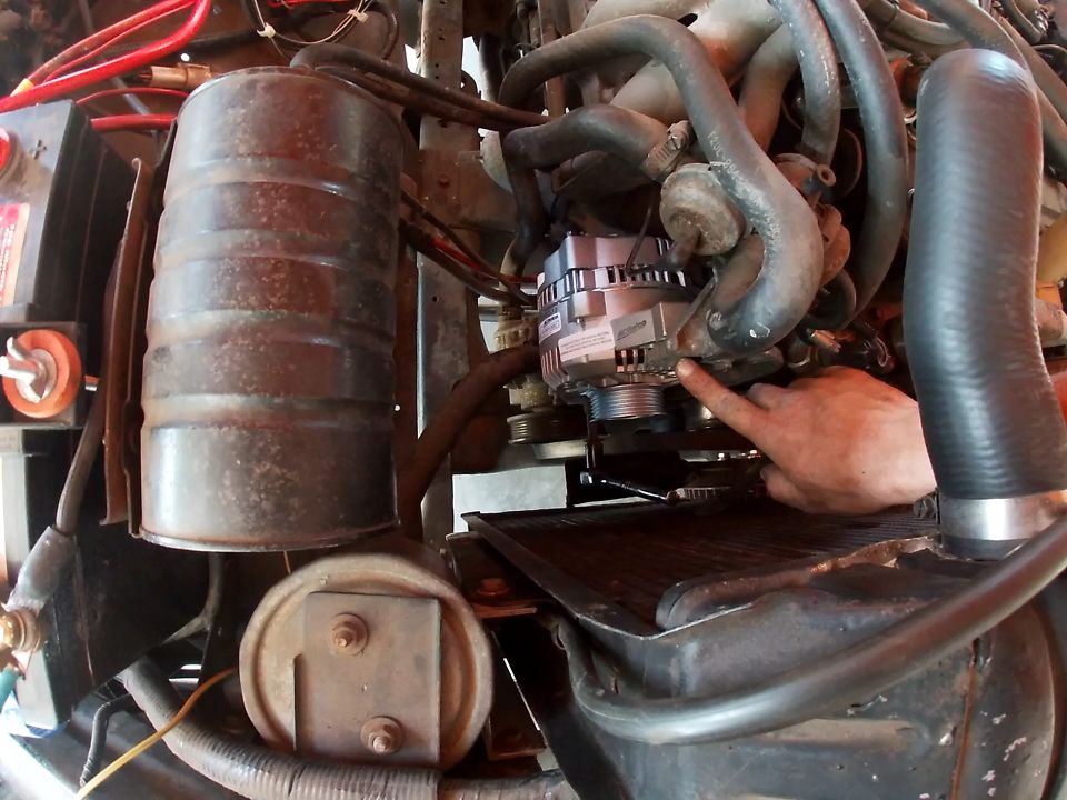 Close-up of a new alternator installed in an engine bay