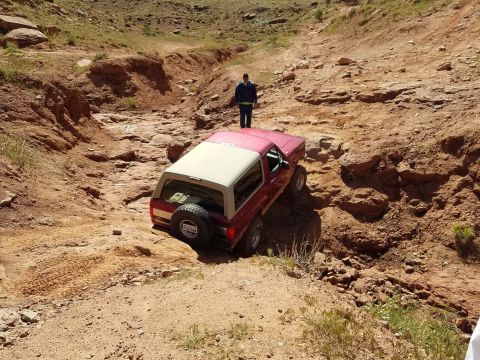 1995 Ford Bronco - A 1995 Ford Bronco tackles a challenging rocky terrain, demonstrating its off-road capabilities.