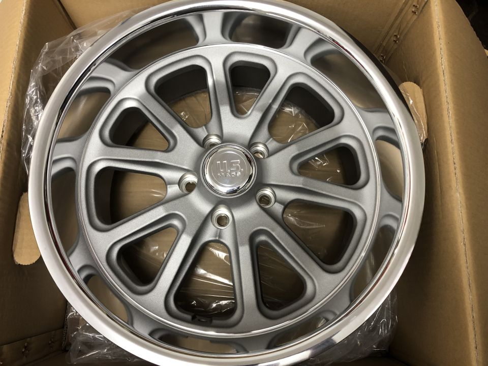 Silver custom aluminum wheel with polished lip and "U.S. MADE" center cap, inside a box.