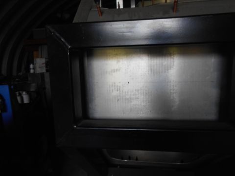 1992 Ford Bronco - A close-up view of a black frame surrounding a metallic surface with horizontal lines. The background is dark and appears to be a workshop…