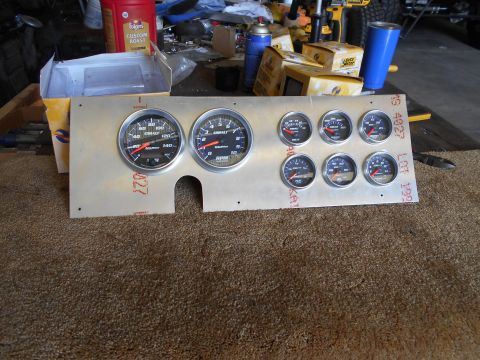 1992 Ford Bronco - A custom aluminum gauge panel with multiple Cobalt gauges is laid out on a carpeted surface. Visible gauges include RPM, speed, volts, wate…