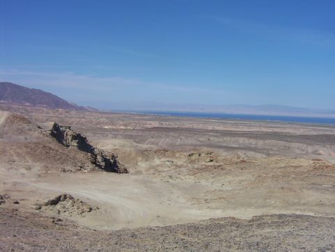 2000 Ford F-450 - Expansive desert terrain with mountains and a distant view of water under a clear blue sky.