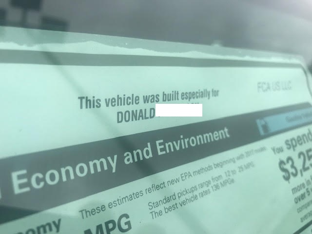 Close-up of a car window sticker with text about the vehicle being built for Donald.