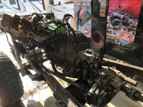 1992 Jeep Wrangler - A disassembled Jeep chassis with the engine and transmission exposed. A bottle of Guinness is perched on the transfer case.