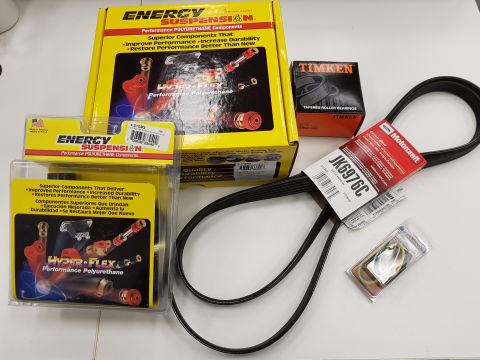 1978 Ford Bronco - A collection of automotive parts including a yellow Energy Suspension box, a smaller Timken box, a Motorcraft drive belt, and a package of…