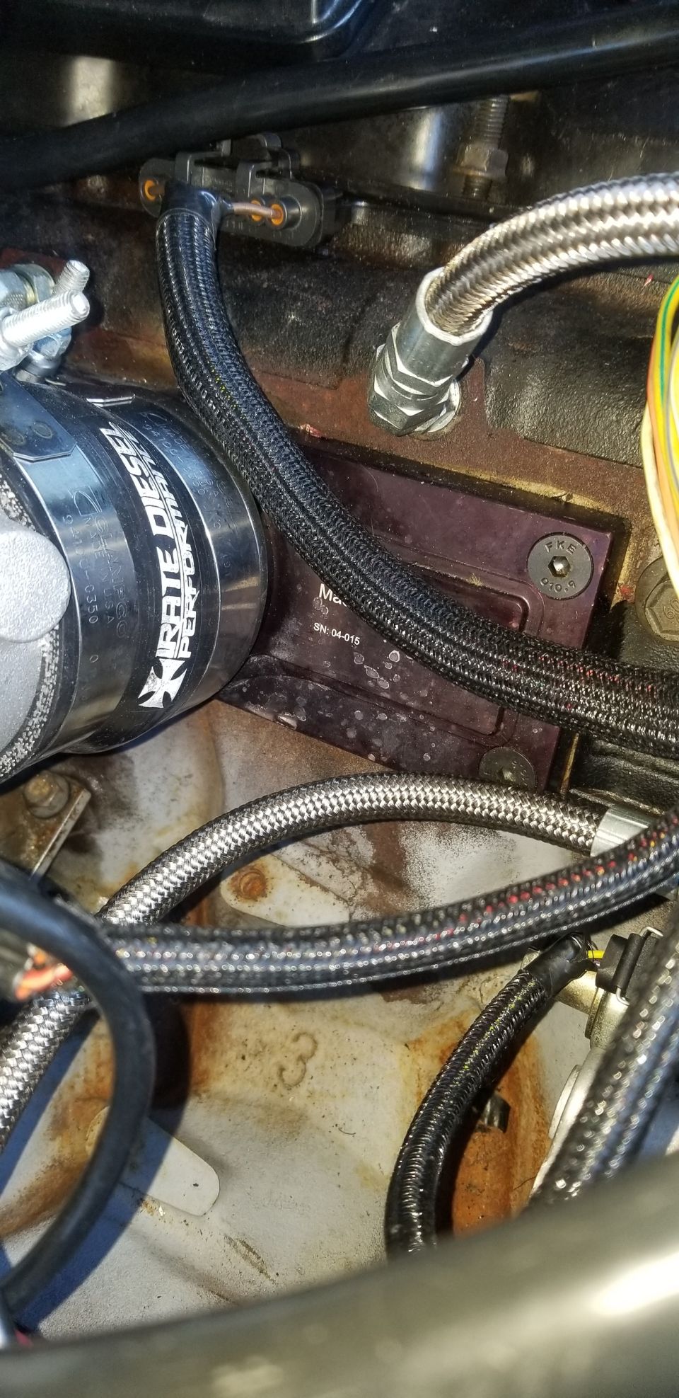 Engine bay with hoses, wiring, and a component labeled Xrate Diesel Performance.