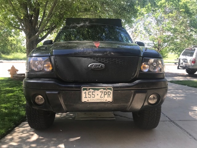 Front view of a black Ford Ranger pickup truck with a custom grille and Colorado license plate.