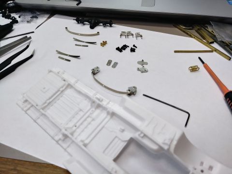 1995 Ford Bronco - Parts laid out with the axle and the chassis.