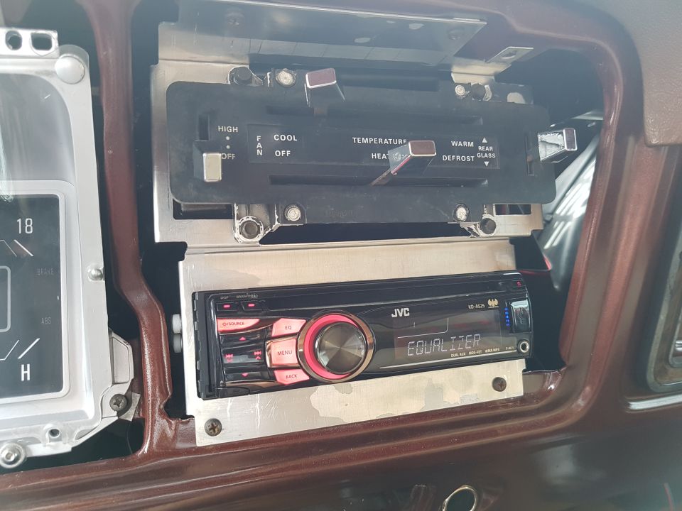Interior of a 1978 Ford Bronco showing JVC stereo and climate controls.