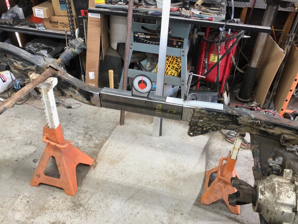 Jeep Wrangler frame being welded with jack stands and tools