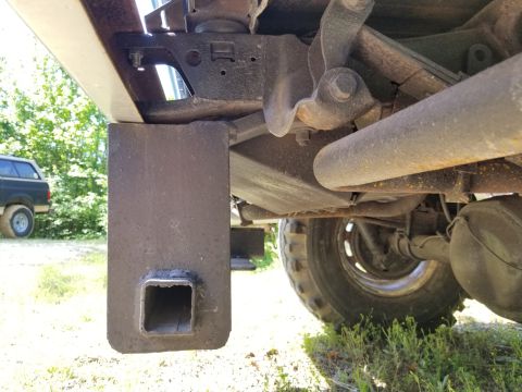 1974 Ford Bronco - One rusty bolt in each frame rail is all that's holding the rear receiver on. There's a hole close to the lower bumper bolt hole, but no bo…